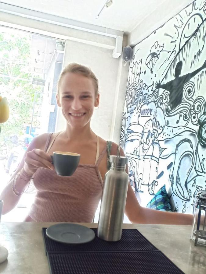 A Pousada Stellar Capsules Seminyak Exterior foto A woman drinking coffee